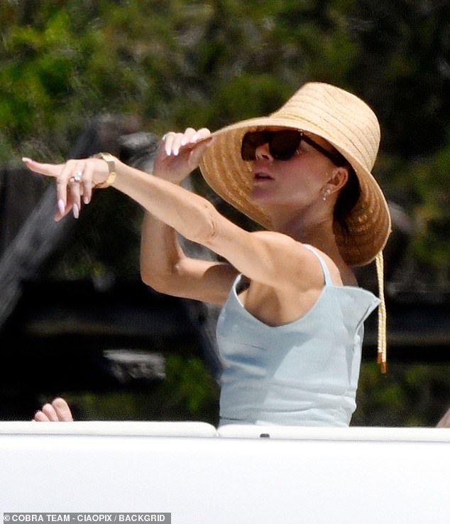 Victoria, 50, meanwhile stayed on board, relaxing on deck in a chic sundress and wide-brimmed hat