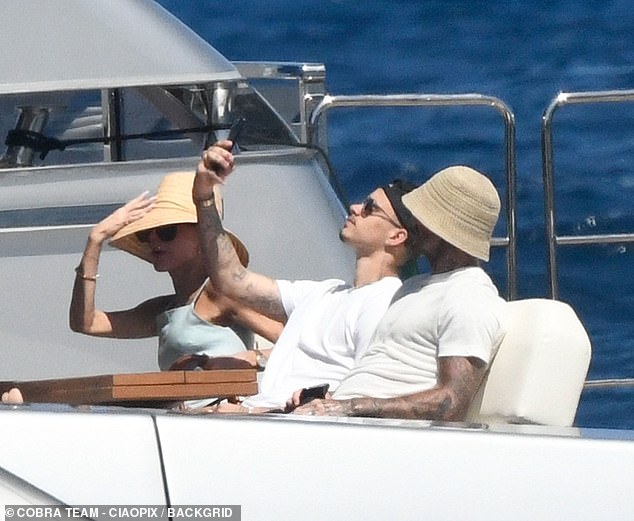 Romeo proved that three's not a crowd as he snapped a selfie with his dad on deck