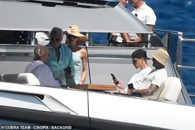 Romeo was seen checking his phone as he holidayed with his parents and their pals