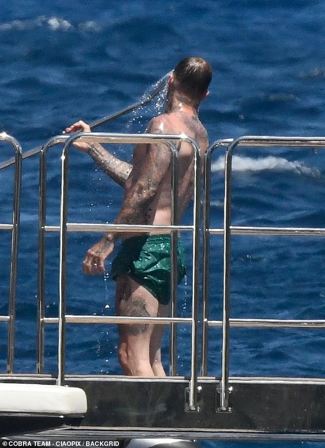 David cooled off in Sardinia heat with his on deck shower before joining his wife