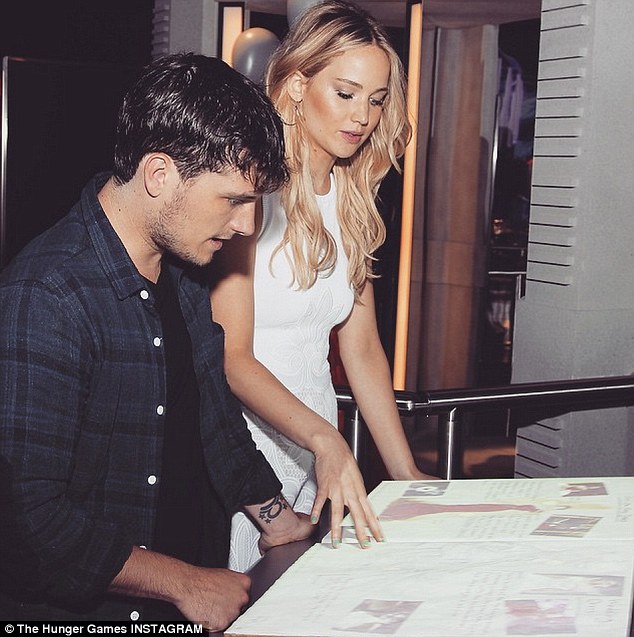 Engrossed: Jennifer and Josh were seen poring over a large tome full of writing and photographs 