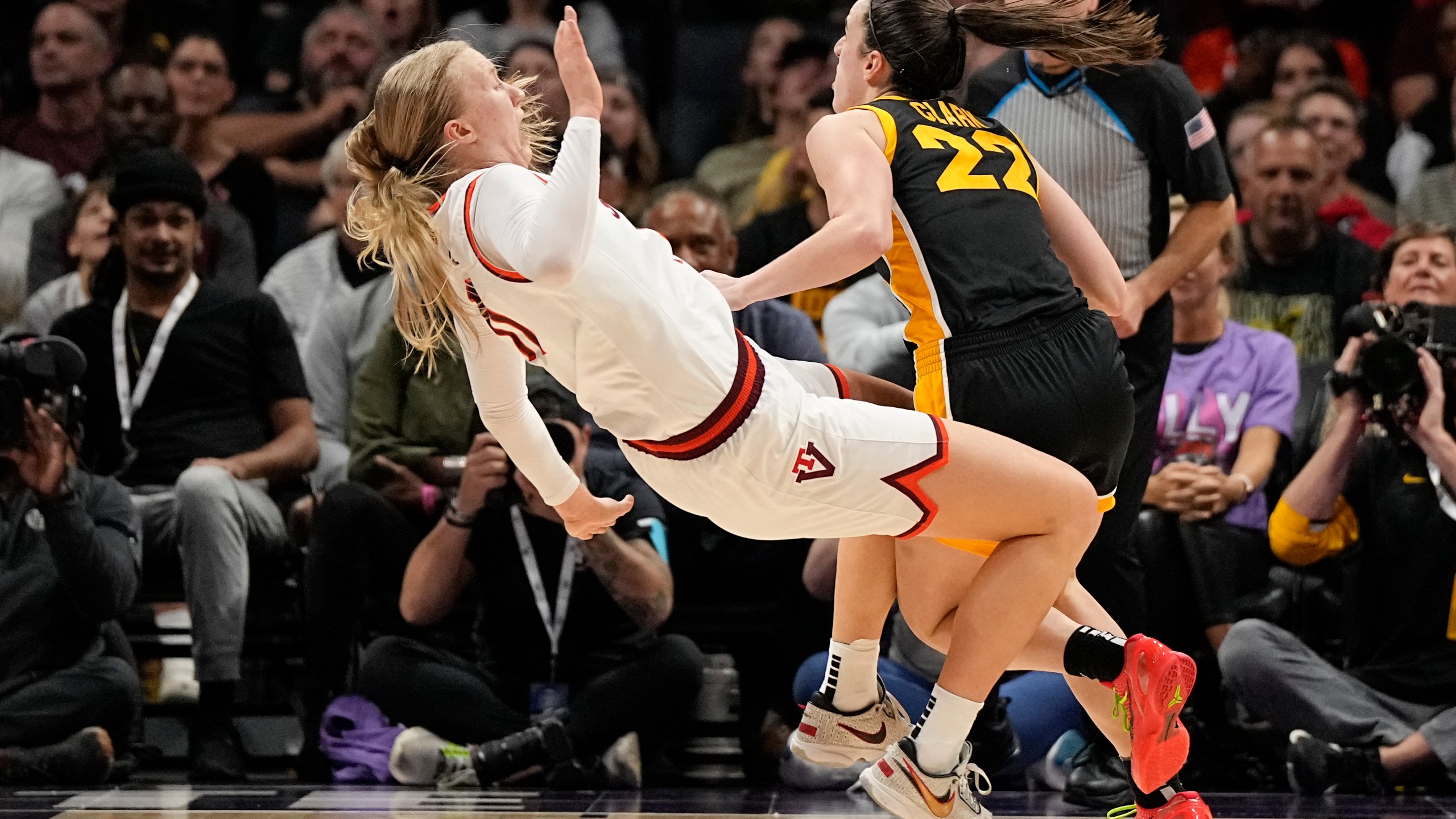 Iowa guard Caitlin Clark drives to the basket past Virginia Tech guard Matilda Ekh during the second half of an NCAA women's college basketball game Thursday, Nov. 9, 2023, in Charlotte, N.C. (AP Photo/Chris Carlson)