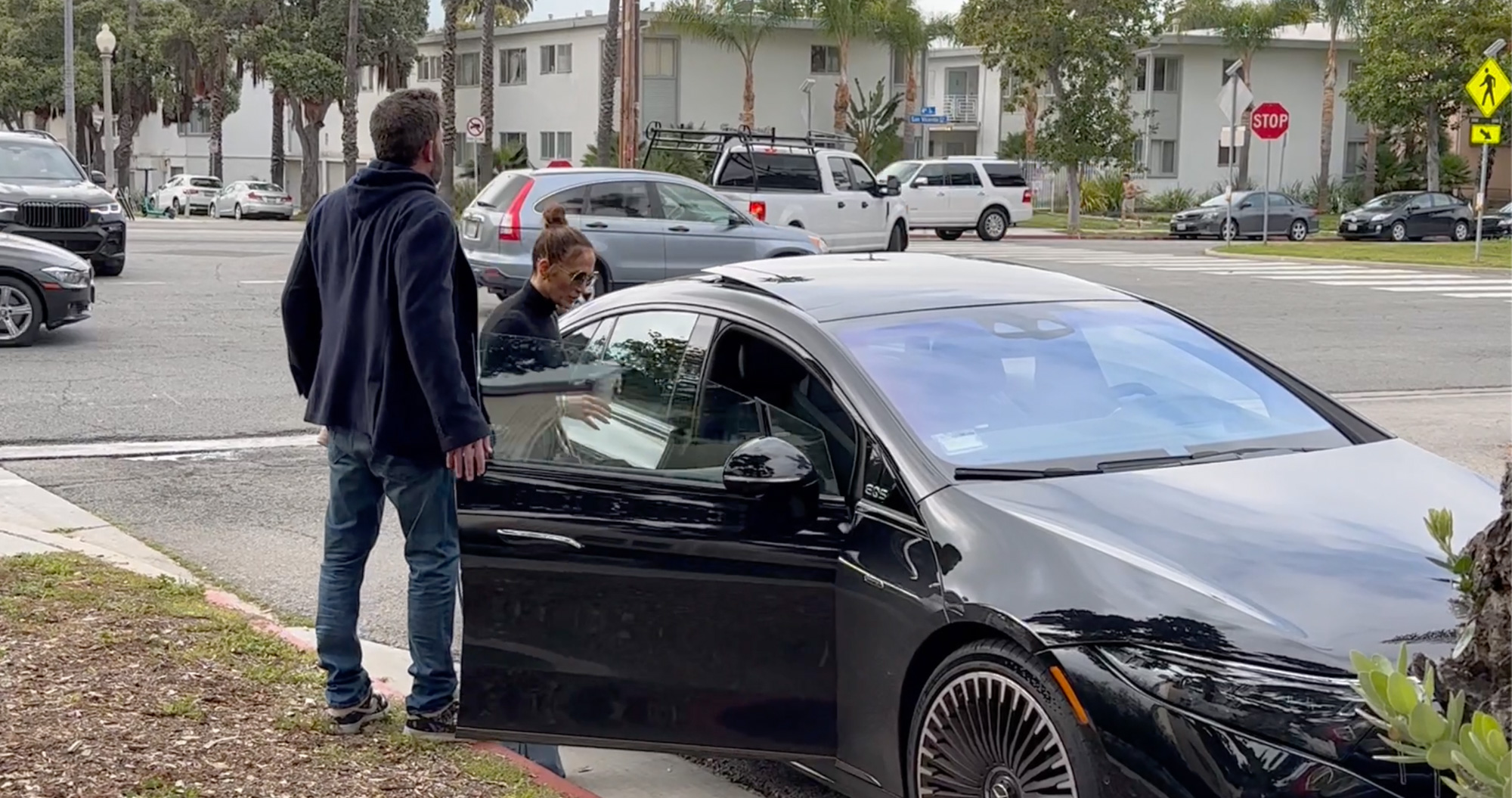 Ben Affleck opening a car door for Jennifer Lopez.